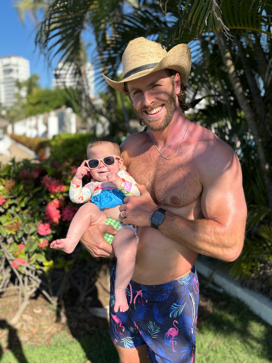 Coach Brett posing outdoors with his daughter.
